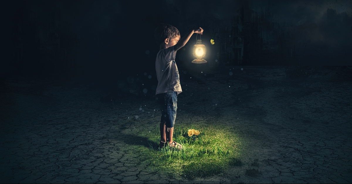 Lost child holding an old lamp in an apocalyptic environment
